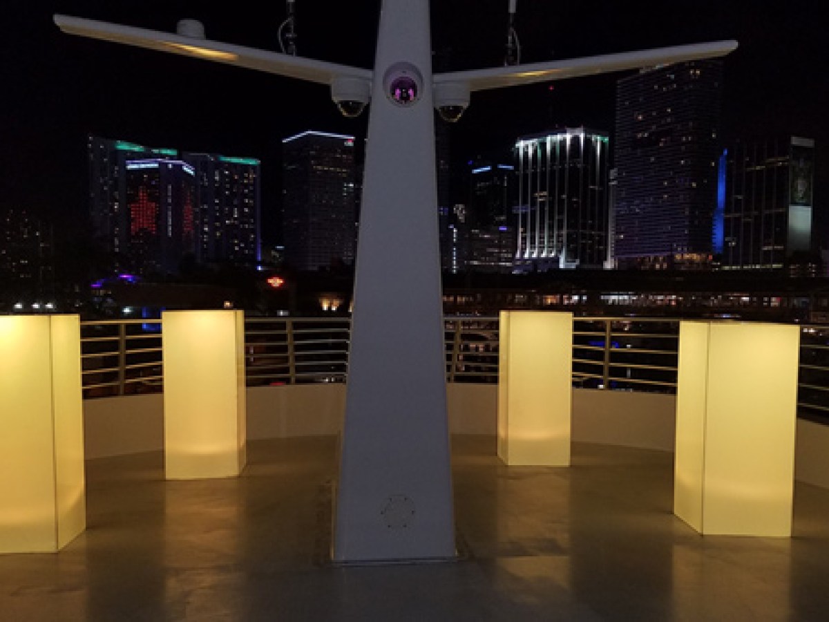 Yacht deck at night with city in bachground