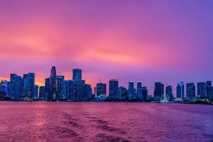 a large body of water with a city in the background