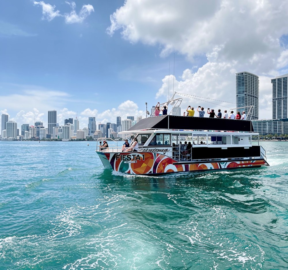 Guests viewing Miami from the upper deck of a Biscayne Bay sightseeing cruise